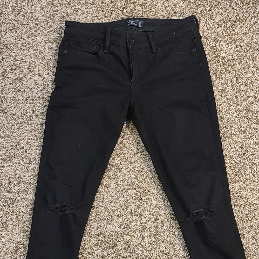 Black skinny jeans with ripped knees